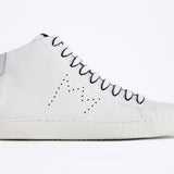 Side profile of mid top white sneaker with full leather upper with perforated crown logo and white sole.