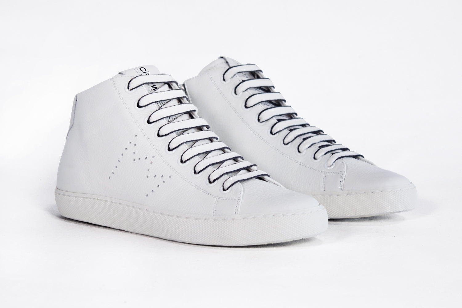 Three quarter front view of mid top white sneaker with full leather upper with perforated crown logo and white sole.