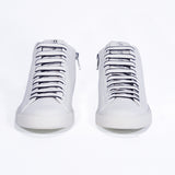 Front view of mid top white sneaker with full leather upper with perforated crown logo and white sole.