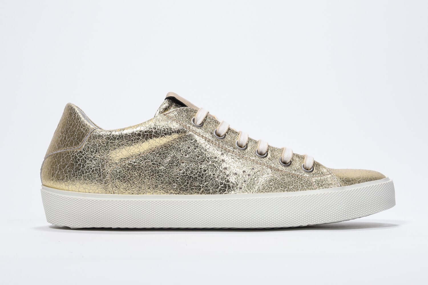 Women's Low-top PURE sneaker in Metallic Gold Leather with a sleek side profile perfect to add shine to any outfit.